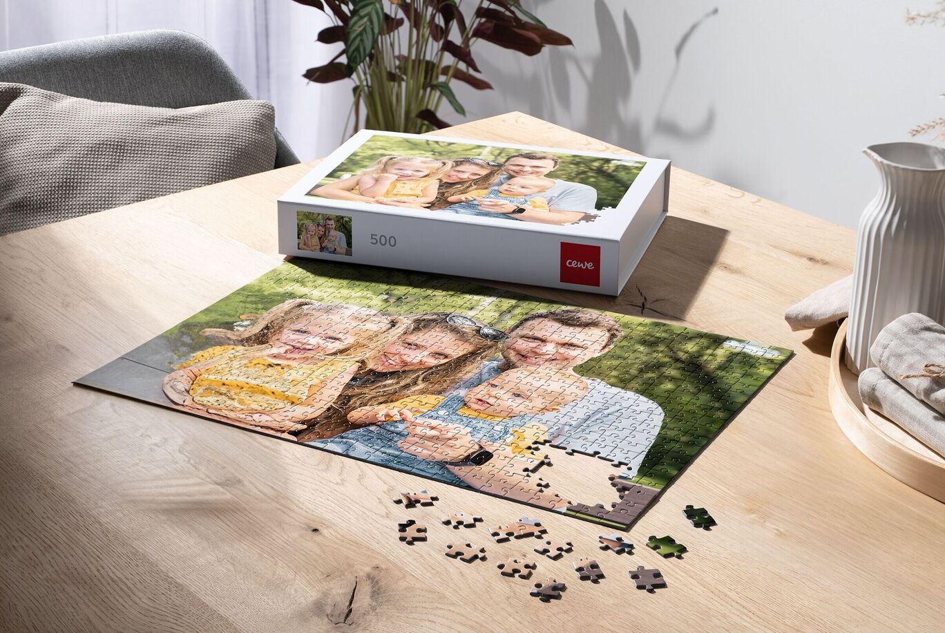 Puzzle with a family photo on a table, surrounded by puzzle pieces